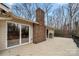 Spacious deck with railing overlooking the backyard and featuring a red brick fireplace at 64 Timberidge Dr, Lake Wylie, SC 29710