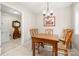 Cozy dining room featuring a wooden table with chairs, a chandelier, and a door leading to an adjacent room at 64 Timberidge Dr, Lake Wylie, SC 29710