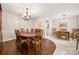 Spacious dining room featuring hardwood floors, a large dining table, and connections to an additional dining area at 64 Timberidge Dr, Lake Wylie, SC 29710