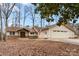 Traditional home exterior features a well-maintained yard, attached garage, and a welcoming front porch with a decorative front door at 64 Timberidge Dr, Lake Wylie, SC 29710