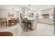 Inviting open-concept kitchen featuring an island with bar stools and a dining area, perfect for casual meals and entertaining at 64 Timberidge Dr, Lake Wylie, SC 29710