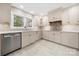 Bright kitchen featuring white cabinets, stainless steel appliances, tile backsplash and a large window overlooking the yard at 64 Timberidge Dr, Lake Wylie, SC 29710