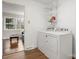 Laundry room with laminate floors and washer and dryer near an open doorway at 64 Timberidge Dr, Lake Wylie, SC 29710