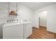 Bright laundry room with white appliances and wire shelving for extra storage at 64 Timberidge Dr, Lake Wylie, SC 29710