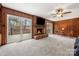 Comfortable living room includes a brick fireplace, wood paneling, and glass sliding doors to deck at 64 Timberidge Dr, Lake Wylie, SC 29710