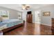 This main bedroom includes hardwood floors, a ceiling fan, and ensuite bathroom at 64 Timberidge Dr, Lake Wylie, SC 29710