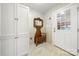 Functional mudroom with a vintage wooden hall tree, white cabinets, and a doorway to the outside offering convenience and storage at 64 Timberidge Dr, Lake Wylie, SC 29710