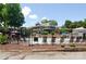 Community pool area with lounge chairs and mature trees with a building in the background at 64 Timberidge Dr, Lake Wylie, SC 29710