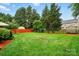 The spacious backyard offers a lush lawn with mature trees, perfect for outdoor activities at 6717 Bickham Ln, Charlotte, NC 28269