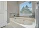 Relaxing bathroom showcasing a soaking tub with window view and modern fixtures at 6717 Bickham Ln, Charlotte, NC 28269