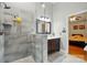 Updated bathroom featuring glass shower with stylish gray tile and dark wood cabinets at 6717 Bickham Ln, Charlotte, NC 28269