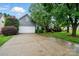 Gray home with a two-car garage, driveway, and well-kept lawn at 6717 Bickham Ln, Charlotte, NC 28269