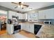 Updated kitchen features stainless steel appliances, granite countertops, white cabinets, and plenty of natural light at 6717 Bickham Ln, Charlotte, NC 28269