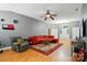 Spacious living room with hardwood floors, fireplace, and a comfortable red sectional sofa, creating a welcoming atmosphere at 6717 Bickham Ln, Charlotte, NC 28269