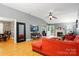 Bright living room with hardwood floors, fireplace, and comfortable red sectional sofa, creating a cozy atmosphere at 6717 Bickham Ln, Charlotte, NC 28269