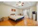 Spacious bedroom with tray ceilings, ceiling fan and hardwood floors at 6717 Bickham Ln, Charlotte, NC 28269