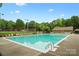 Resort-style pool with crystal-clear water and plenty of lounge chairs under the beautiful blue sky at 6717 Bickham Ln, Charlotte, NC 28269