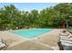Sparkling outdoor pool surrounded by lounge chairs for residents to relax and enjoy the sunshine at 6717 Bickham Ln, Charlotte, NC 28269