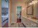 Bathroom with vanity and sink, leading to bedroom and walk-in closet, offering style and functionality at 7122 Marlin St, Gastonia, NC 28056