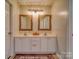 Well-lit bathroom with a double vanity, decorative mirrors, and modern fixtures, offering style and functionality at 7122 Marlin St, Gastonia, NC 28056