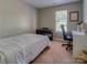 This bedroom offers a serene setting with a cozy bed and functional workspace at 7122 Marlin St, Gastonia, NC 28056