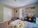 A bright and inviting bedroom with organized shelves and play area at 7122 Marlin St, Gastonia, NC 28056