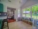 Bright breakfast nook with large windows and built-in shelving with backyard views and pass-through to living room at 7122 Marlin St, Gastonia, NC 28056