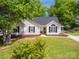 Charming home featuring a well-maintained lawn, manicured landscaping, and classic architectural details at 7122 Marlin St, Gastonia, NC 28056