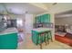 Cozy kitchen with breakfast bar, featuring stylish green cabinetry and a mosaic tile backsplash. Includes seating at 7122 Marlin St, Gastonia, NC 28056