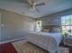 Bedroom features a comfortable king bed, ceiling fan, and natural light from the windows, offering a relaxing retreat at 7122 Marlin St, Gastonia, NC 28056