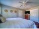 Inviting bedroom features a bed, ceiling fan, wood dresser with TV, and closet for ample storage at 7122 Marlin St, Gastonia, NC 28056