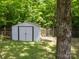 View of metal storage shed with double doors in the back yard at 7122 Marlin St, Gastonia, NC 28056