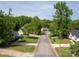 A beautiful street view of the home's neighborhood with mature trees at 7122 Marlin St, Gastonia, NC 28056
