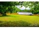 Expansive backyard featuring a well-maintained lawn and a secure wooden fence and solar panels at 745 Rock Castle Dr, York, SC 29745