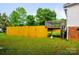 Large backyard with a wooden fence, deck and lush green grass at 745 Rock Castle Dr, York, SC 29745