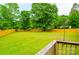 Fenced backyard showcasing a lush green lawn and providing a secure outdoor space from the wooden deck at 745 Rock Castle Dr, York, SC 29745