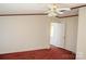 Bedroom with ceiling fan and carpet leading to an adjoining doorway at 745 Rock Castle Dr, York, SC 29745