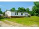 View of a single-story home with a brick foundation, deck and open yard, offering a welcoming curb appeal at 745 Rock Castle Dr, York, SC 29745