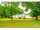 Charming single-story home with a well-maintained lawn and ample greenery at 745 Rock Castle Dr, York, SC 29745