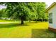 View of the well-maintained front yard with mature trees adding shade and beauty at 745 Rock Castle Dr, York, SC 29745