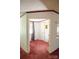 Red carpet in hallway leading to a closet with a built-in desk and shelves at 745 Rock Castle Dr, York, SC 29745