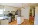Well-equipped kitchen boasts stainless steel appliances, white cabinetry, and a convenient island for meal prep at 745 Rock Castle Dr, York, SC 29745