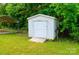 Storage shed in the backyard, providing extra space for tools and equipment with a carport in the background at 745 Rock Castle Dr, York, SC 29745