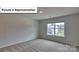Bright bedroom with carpet flooring and large window at 8013 Kennesaw Dr, Gastonia, NC 28056