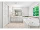 Elegant bathroom featuring double sinks, a separate shower, and a luxurious soaking tub at 8709 Huntland Ct, Charlotte, NC 28277