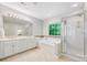 Elegant bathroom featuring double sinks, a separate shower, and a luxurious soaking tub at 8709 Huntland Ct, Charlotte, NC 28277