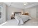 Calm bedroom with soft carpet, a tray ceiling, and neutral tones at 8709 Huntland Ct, Charlotte, NC 28277