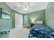 Green bedroom with a single bed, ceiling fan, and closet at 8709 Huntland Ct, Charlotte, NC 28277