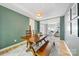 Lovely dining room showcasing green walls, a wooden table, and bright, natural light at 8709 Huntland Ct, Charlotte, NC 28277