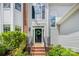 Close-up of the front door with a decorative wreath and well-maintained landscaping surrounding the entrance at 8709 Huntland Ct, Charlotte, NC 28277